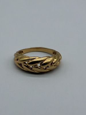 an image of a gold ring on a white surface