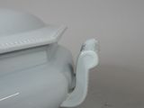 an image of a white porcelain bowl with a lid on a table