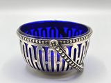 a close up of a blue glass bowl on a white surface