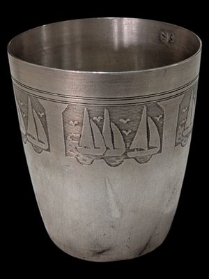 a silver cup that has a design on it