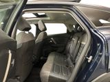 the back seats of a car with the door open and the driver ' s seat down