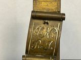 a brass plate with a bird on it on a table