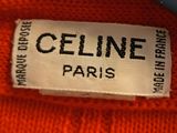 an orange sweater label with the name celine paris on it