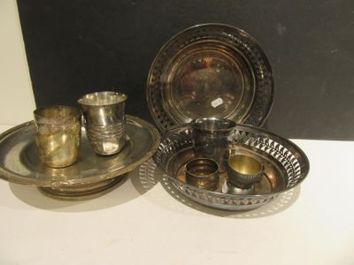 three silver plated dishes and cups on a white table
