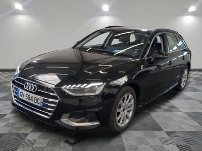 a black audi parked in a garage with a checkered floor
