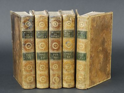 three old books sitting on top of each other on a table