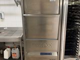 a stainless steel refrigerator in the middle of a kitchen