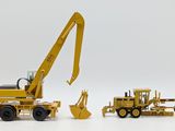 two toy trucks and a bulldozer on a white surface
