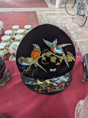 a plate with a bird design on it on a table