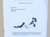 a piece of paper with a drawing of a woman laying on the ground