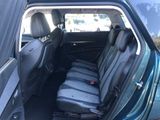 the back seats of a blue car with black seats in the back of it