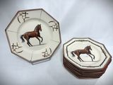 two plates with a horse on them on a table