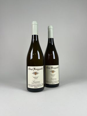 two bottles of wine sitting next to each other on a table