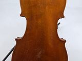 an old violin sitting on top of a white surface