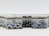two blue and white boxes sitting on a white surface