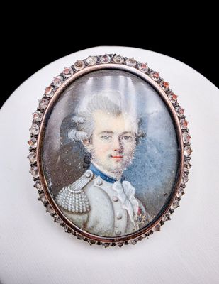 portrait d'un homme vêtu d'une blouse blanche et d'un nœud papillon bleu