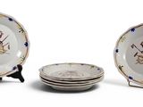 three plates with designs on them sitting on a table