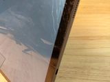 a laptop computer sitting on top of a wooden table