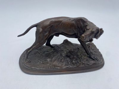 statue of a dog on a rock on a white background
