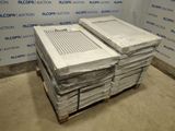 a stack of air conditioners on a pallet in front of a wall