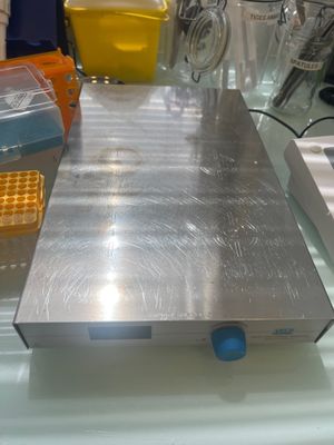 a metal plate on a glass table with other items on it