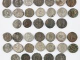 an assortment of ancient roman coins on a white surface