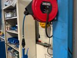 a red fire hydrant sitting on a shelf in a garage