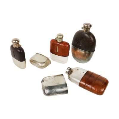 five different types of perfume bottles on a white surface