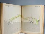 an open book with a map on it sitting on a table