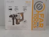 the box is open to show the contents of the drill