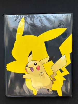 a close up of a pokemon pikachu sticker on a black surface