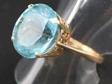 an image of a ring with a blue topazt stone in it