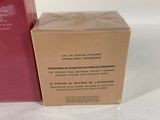 packaging of a red box and a pink box on a white surface