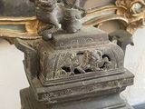 a bronze statue of a bird on top of a box