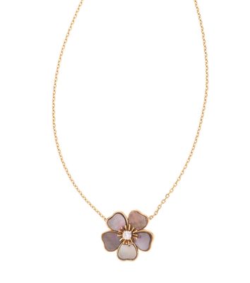 a gold necklace with a flower pendant on a chain