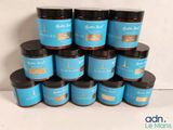 a pile of jars of body butter sitting on top of each other