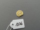 a gold coin and a tag with a picture of a woman