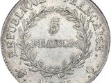 a close up of a silver coin with a wreath on it