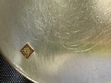 a close up of a metal object with a diamond on it