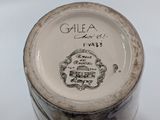 a close up of a vase with writing on it