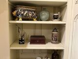 a cabinet with a lot of items on top of it
