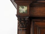 a clock on the top of a tall wooden cabinet