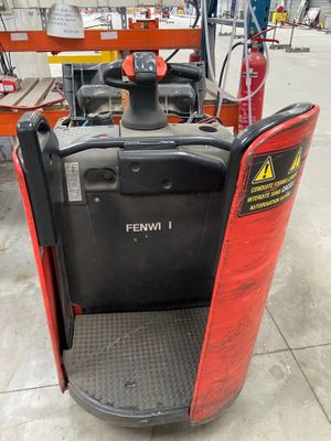 a forklift with a red cover on it in a warehouse