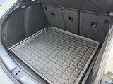 the trunk of a car with a metal grate in the trunk
