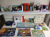 a lot of books and games on a shelf