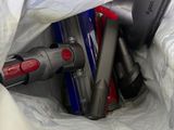 a bag of vacuum cleaners and other household items in it