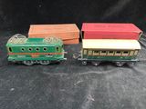 three toy trains sitting next to each other on a black surface