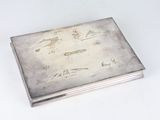 an old silver box sitting on top of a white table
