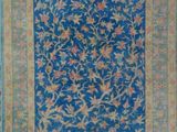 a blue rug with a floral design on it