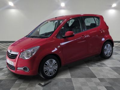 the small red car is parked in the garage on a checkered floor